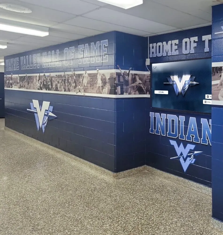 Athletic heritage hallway featuring school mascot and historical recognition Heritage hallway with mural